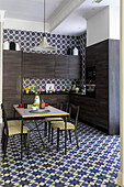 Dining area and dark wood furniture in the kitchen with decorative tiles