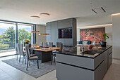 Modern dining room open to integrated kitchen and views of the countryside