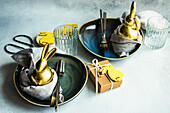 Festive table setting with blue plates and golden bunny