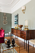 Blend of vintage and contemporary pieces, sideboard and bespoke armchair in red velvet