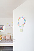 Children's room with DIY hot air balloon wall decoration and bed