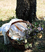 Picnic basket with blankets and flowers
