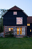 Former mill and barn converted into home at dusk