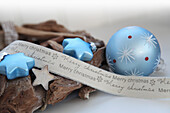 Blue glass baubles and glass stars with driftwood wreath