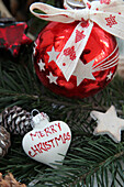 Red glass baubles, pine cones, white heart pendant and wooden star