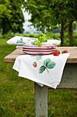 DIY fabric napkins with strawberry motif on garden table