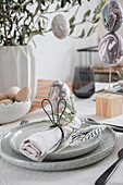 Easter decoration with marbled eggs and napkin ring with bunny ears