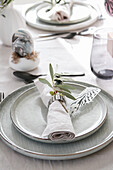 Easter table setting with olive branch, feather and marbled egg