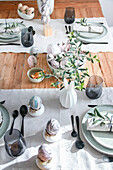 Easter table with marbled eggs and olive branch decoration