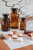 Apothecary bottles and handmade soaps on paper