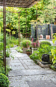 Paved path and climber-covered pergola in garden