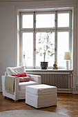 Armchair and footstool at window of 20th century Stockholm apartment