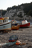 Fishing boats and lobster pot on Devon beach