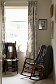 Man's jacket and ties hang over chairs at Arundel window, West Sussex