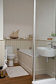 Bird statue and model boat in tongue and groove bathroom in Arundel, West Sussex
