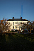 Building exterior with flagpole and winter trees