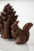 Chocolate squirrel with decorations in background