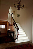 Christmas garland on banister and uncarpeted staircase