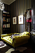 Gold striped wallpaper and leather recliner in home of London fashion designer