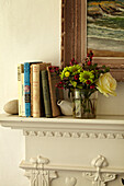 Books on mantlepiece in Norfolk beach house, UK