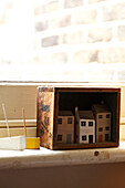 Hand painted dolls houses with toy boats on windowsill in Brighton home, UK