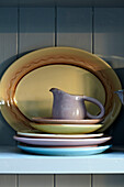 Jug and plates on kitchen dresser in Brighton home, Sussex, UK