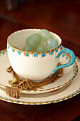 Vintage teacup and saucer with gold jewellery