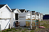 Line of beach huts on West Sussex coastline, England, UK