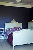 Gestreifte Decken im lila Schlafzimmer eines Stadthauses in Brighton, Sussex, England, UK