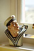 Sailor statue on windowsill of Cromer beach house, Norfolk, England, UK