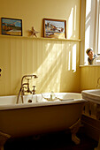 Freestanding roll top bath in Cromer beach house, Norfolk, England, UK