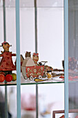 Children's toys in glass cabinet
