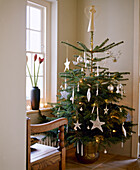 Decorated Christmas tree in corner of room