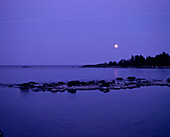 Evening landscape of the moon over the lake