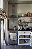 Backofen aus Edelstahl neben einem weißen Schrank in einer Küche im Landhausstil