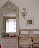 Sitting room with chairs and carved mirror on chest of drawers