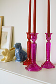 Detail of a shelf with pink candlesticks