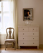 Gustavian chair next to chest of drawers