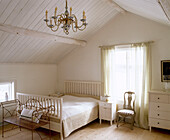 Gustavianischer Stuhl neben dem Bett in einem traditionell skandinavischen Schlafzimmer