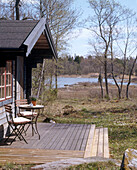 An exterior view of decked area of wooden summerhouse