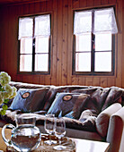 Swiss chalet sitting room with wood panelling and sofa and coffee table