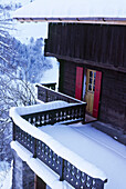 Exterior of snow covered Swiss chalet with balcony