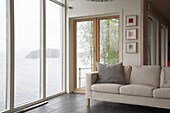 Contemporary sofa in bay window overlooking lake