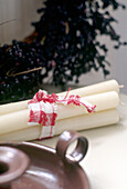 A detail of candles tied with fabric candle holder