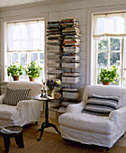 Covered upholstered armchairs with side of book shelf