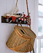 Wicker fishing basket hanging from hook rail