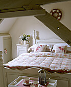 Wooden double bed in country style bedroom