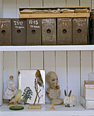 Close up of shelves of ornaments and a row of antique storage boxes