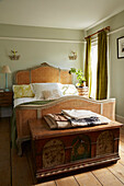 Wicker bed in light green Port Issac beach house bedroom Cornwall