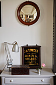 Vintage mirror above storage boxes with desk lamp in Shoreham by Sea, West Sussex, UK